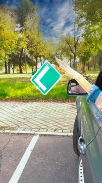 Young driver throwing l-plate away after passing driving test Stock Photos