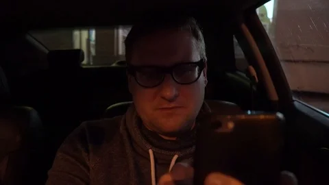 Young driver using a smartphone inside his car. Stock Footage 89287188