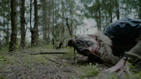 Young druid puts ear on ground to communicate with ghosts Stock Footage 162158174