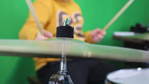 Young Drummer (No Face) Plays Drums And Cymbals On A Green Background Stock Footage 292979619