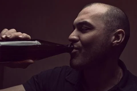 Young drunk man with beer bottle Stock Photos