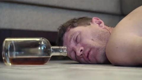 A young drunk man sleeps on the floor. Stock Footage 100626421