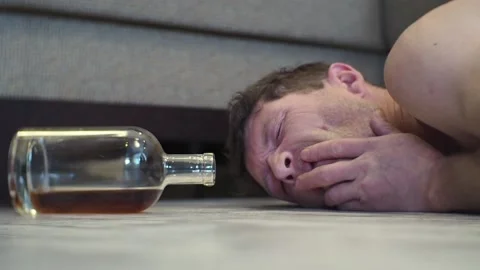 A young drunk man sleeps on the floor. Stock Footage 100626523