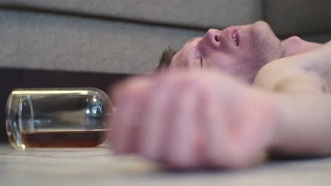 A young drunk man sleeps on the floor. Stock Footage 100626541