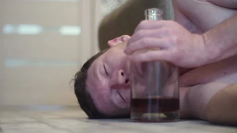 A young drunk man sleeps on the floor. Stock Footage 100626614