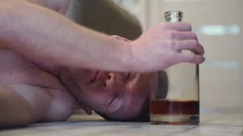 A young drunk man sleeps on the floor. Stock Footage 100626640