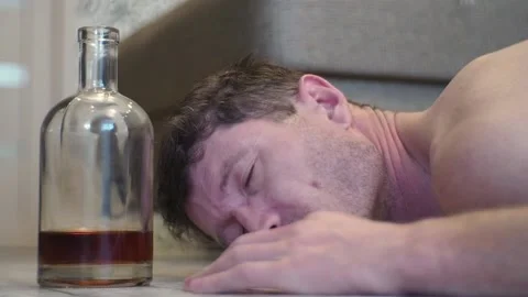 A young drunk man sleeps on the floor. Stock Footage 100626700
