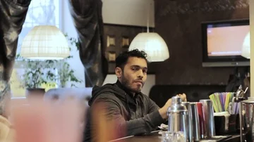 A young Dubai guy in a cafe drinks coffee Stock Footage 85640683