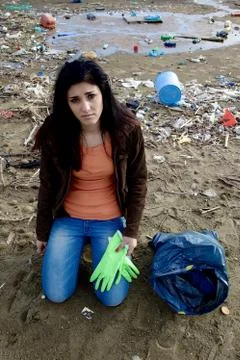 Young ecologist sad about dirty beach Stock Photos