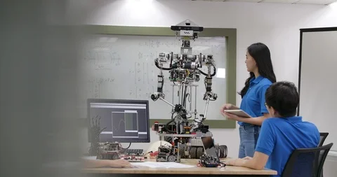 Young electronics engineer team collaborating on construction of robot. Video stock 111832540