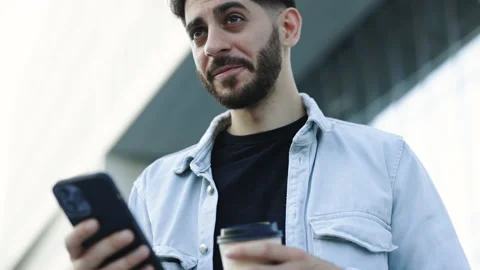 Young elegant bearded man using social media application on smartphone text Stock Footage 200253688