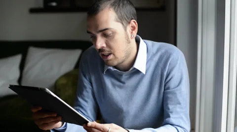 Young elegant man multitasking using notebook, cellphone and tablet Stock Footage 32628527