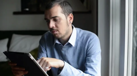 Young elegant man multitasking using notebook, cellphone and tablet Stock Footage 32628543