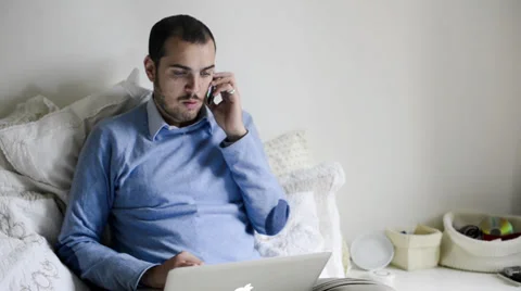 Young elegant man multitasking using notebook, cellphone and tablet Stock Footage 32628558