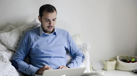 Young elegant man multitasking using notebook, cellphone and tablet Stock Footage 32628565