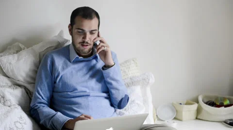 Young elegant man multitasking using notebook, cellphone and tablet Stock Footage 32628582