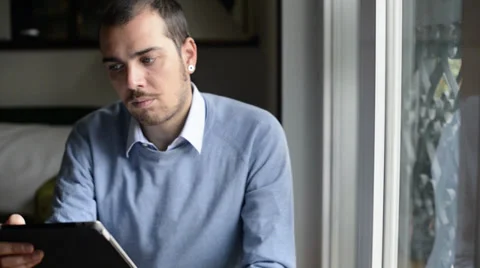 Young elegant man multitasking using notebook, cellphone and tablet Stock Footage 32628583