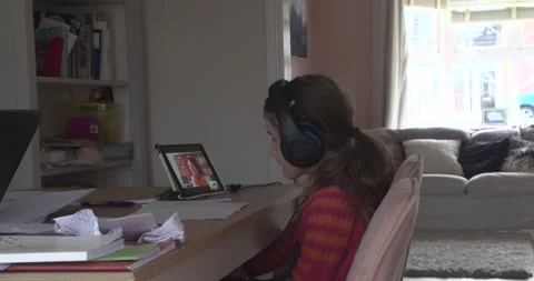 A young elementary school child is in home school as she chats to her teacher Stock Footage 147419035
