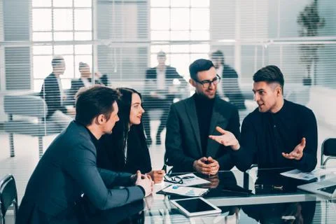 Young employee explaining his ideas to colleagues. Stock Photos