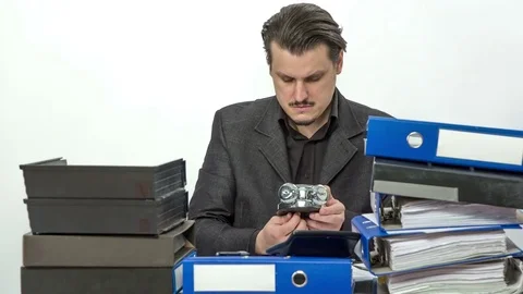 Young employee is setting alarm clock Stock Footage 74870890