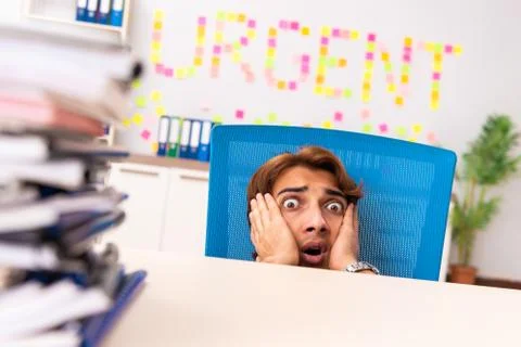 Young employee suffering from excessive work Fotos Stock