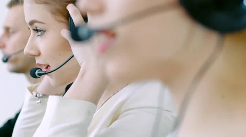Young employee working with a headset and accompanied by her team Video stock 61304004