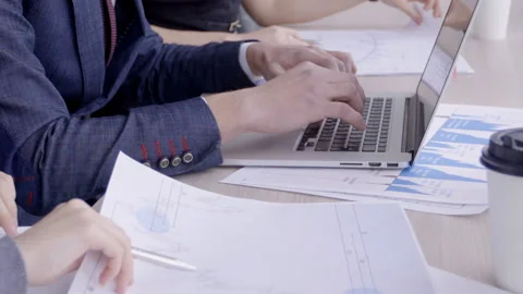 Young employees are working using laptop at table in coworking space. Stock Footage 85635331