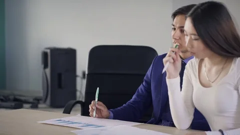 Young employees talking sitting at table in office company. Stock Footage 78111228
