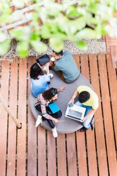 Young employees using modern wireless technology while working outdoors Stock Photos