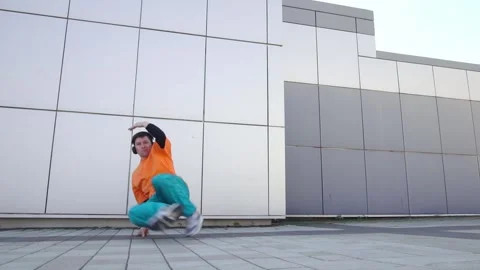 Young energetic guy dancer breakdancing outdoors in the city on the street Stock Footage 295068911