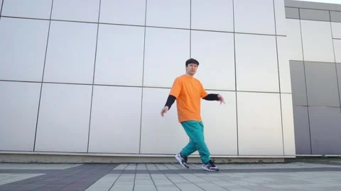 Young energetic guy dancer breakdancing outdoors in the city on the street Stock Footage 295685546