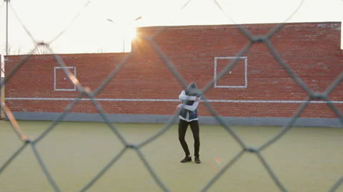 Young energetic guy, a street dancer in black pants and a white sweater Stock Footage 108609178