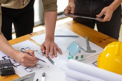 Young engineer architect sketching drawing project plan building construction Stock Photos