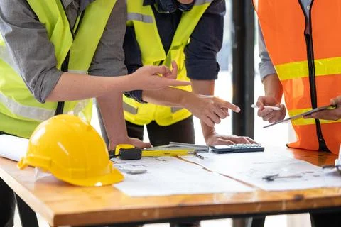 Young engineer architect sketching drawing project plan building construction Fotos de archivo
