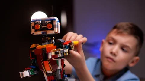 Young engineer assembling a robot from plastic bricks 스톡 사진