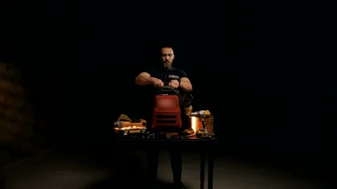 Young engineer with a beard collects tools in a special bag Video stock 151646295