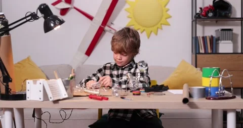 Young engineer. Boy passionate about electronics. DIY kid. Inventions and Stock Footage 171863525
