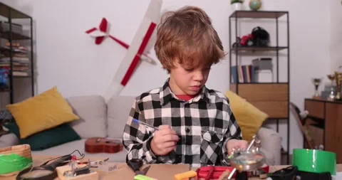 Young engineer. Boy passionate about electronics. DIY kid. Inventions and Stock Footage 171864463