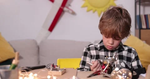 Young engineer. Boy passionate about electronics. DIY kid. Inventions and Stock Footage 172162751
