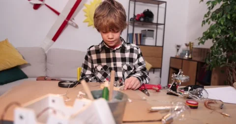 Young engineer. Boy passionate about electronics. DIY kid. Inventions and Stock Footage 172163004
