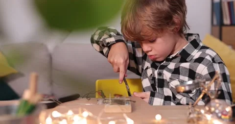 Young engineer. Boy passionate about electronics. DIY kid. Inventions and Stock Footage 172565977