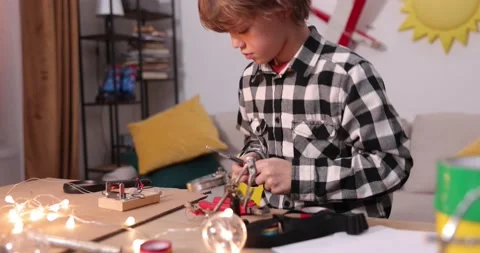Young engineer. Boy passionate about electronics. DIY kid. Inventions and Stock Footage 172566130