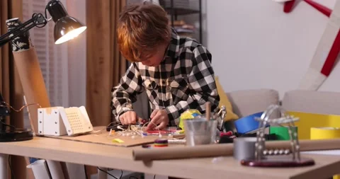 Young engineer. Boy passionate about electronics. DIY kid. Inventions and Stock Footage 172566207