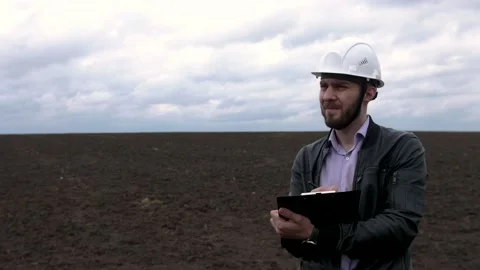 Young engineer builder in a white helmet writes on the tablet. Stock Footage 153273412