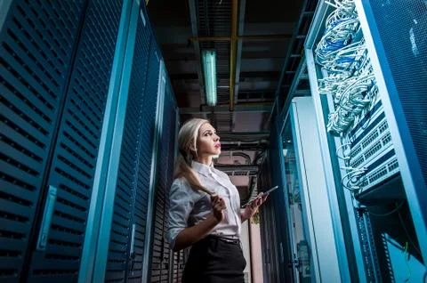 Young engineer businesswoman in network server room Stock Photos
