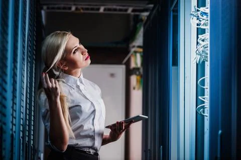 Young engineer businesswoman in network server room Stock Photos