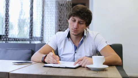 A young engineer in a cafe makes a payment with a phone and a terminal Stock Footage 82160321