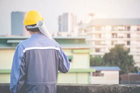 The young engineer is checking the blueprints carefully. For success Foto stock