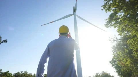 An young engineer is checking a correct operation and efficiency of windmills Video stock 141372411