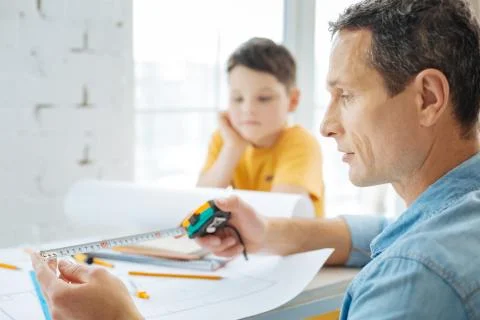 Young engineer checking the measure on the tape Stock Photos